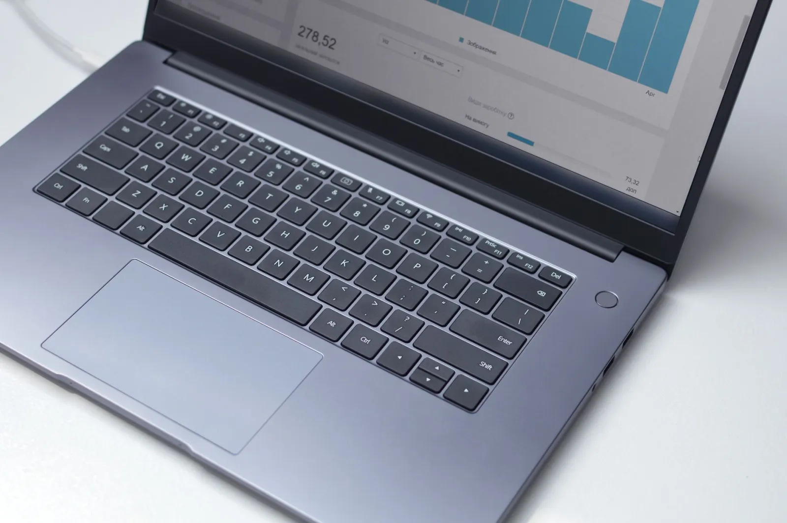 Notebook sobre a mesa exibindo gráficos de um painel de dados